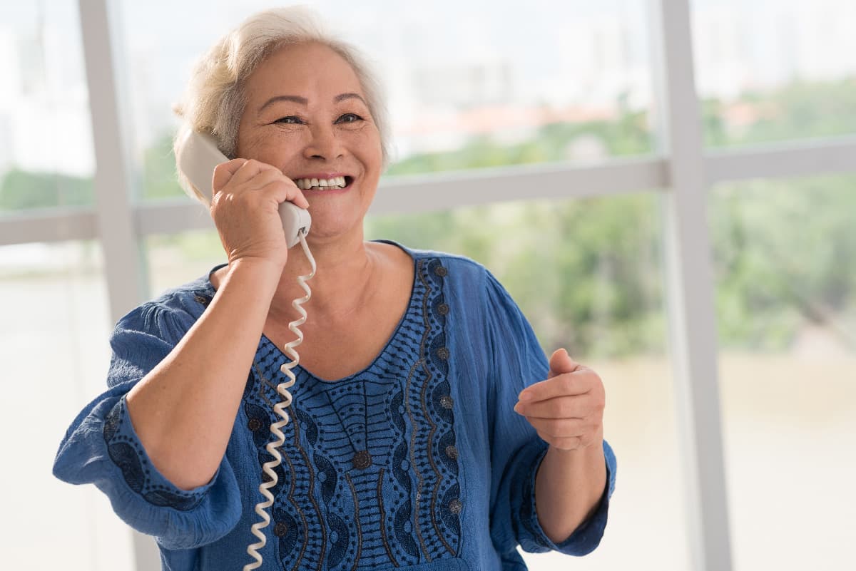 Senior citizen smiling talking on a phone